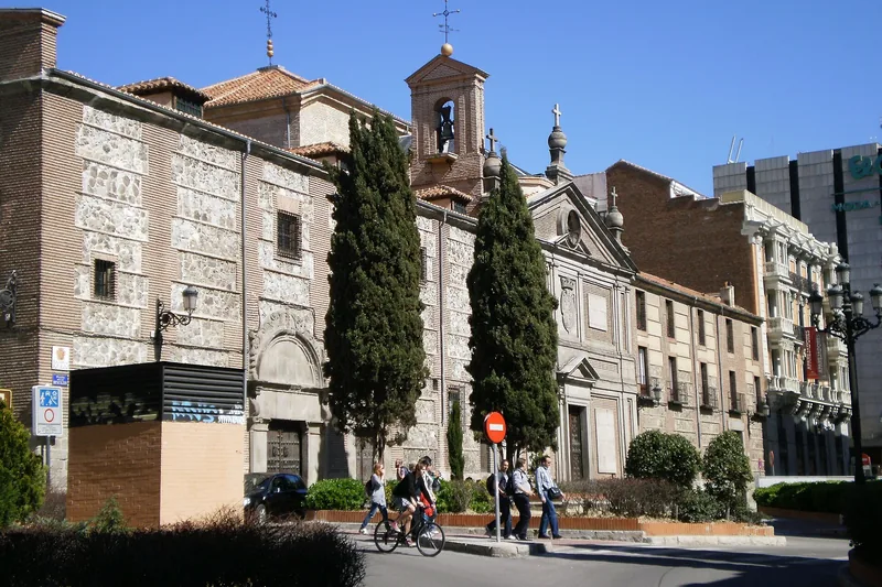The long convent wall running down the side of the square